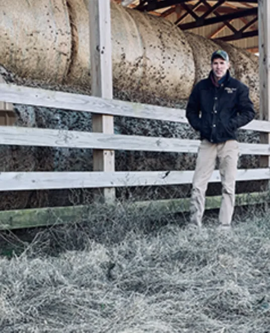 Zach Tincher, vice president of D.T. Construction, standing by a hay barn